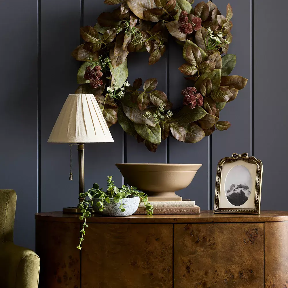 Console with antique brass picture frame